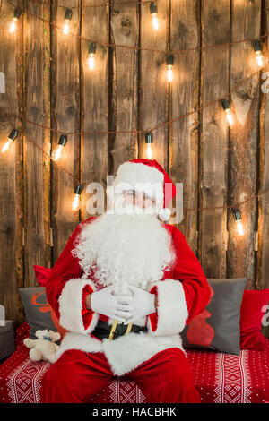 Santa Claus: Cheerful With Small Stack Of Gifts Stock Photo