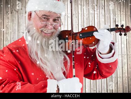 Happy santa playing violin Stock Photo