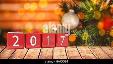 2017 in blocks on wooden plank against a composite image 3D of christmas background Stock Photo