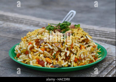 Bhelpuri is a savoury snack or chaat. It is made out of puffed rice, vegetables and a tangy tamarind sauce Stock Photo