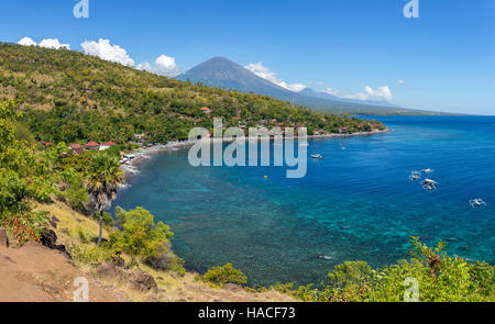 Jemeluk Beach and beautiful blue lagoon with Gunung Agung volcano on background. Amed village, East of Bali, Indonesia. Stock Photo