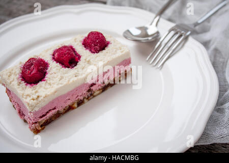 Raw cashew cake (cheesecake) and berries (strawberries, cherries), lavender on a wooden background. . Perfect for the detox diet or just a healthy des Stock Photo