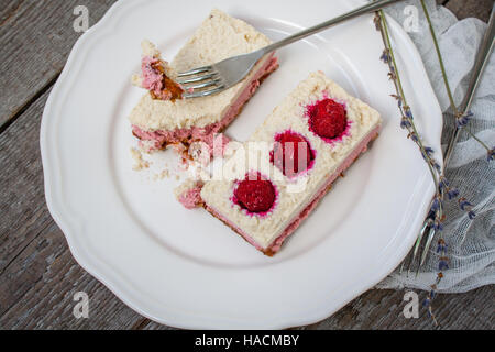 Raw cashew cake (cheesecake) and berries (strawberries, cherries), lavender on a wooden background. . Perfect for the detox diet or just a healthy des Stock Photo