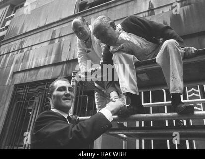 Jack Bodell (l) who won the British, European and Commonwealth heavyweight title from Joe Bugner last night is congratulated by painters, Harold Baron (l), of Marylebone, and Tom McLennon, of Nunhead, as he went out from the Cumberland Hotel in London. Stock Photo
