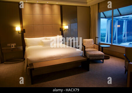 SINGAPORE - JULY 23rd, 2016: luxury Hotel room with modern interior, a comfortable bed and an awesome view of the Marina Bay Stock Photo