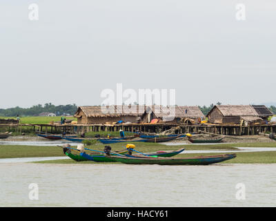 Fishing village and boats at the banks of Kaladan River in the Rakhine State of Myanmar. Stock Photo