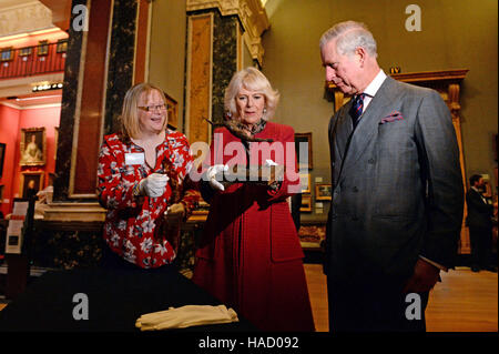 The Duchess of Cornwall holds a wax sculpture by Edgar Degas titled Arabesque over the Right Leg, Left Arm in Front as she and the Prince of Wales visit the University of Cambridge's Fitzwilliam Museum to mark its bicentenary and to celebrate the 600th anniversary of the Cambridge University Library. Stock Photo