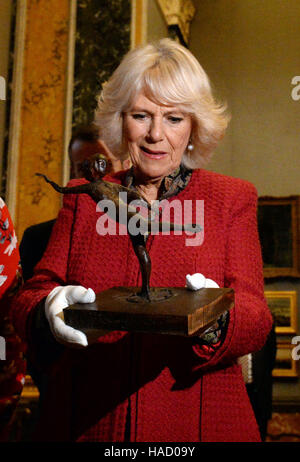 The Duchess of Cornwall holds a wax sculpture by Edgar Degas titled Arabesque over the Right Leg, Left Arm in Front as she visits the University of Cambridge's Fitzwilliam Museum to mark its bicentenary and to celebrate the 600th anniversary of the Cambridge University Library. Stock Photo