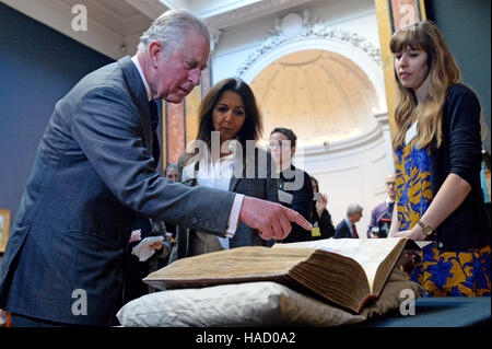 The Prince of Wales examines a copy of Charles Darwin's On the Origin of Species by Means of Natural Selection during a visit to the University of Cambridge's Fitzwilliam Museum to mark its bicentenary and to celebrate the 600th anniversary of the Cambridge University Library. Stock Photo