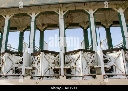 Empty horse racing starting gate rusting against blue skies. Stock Photo