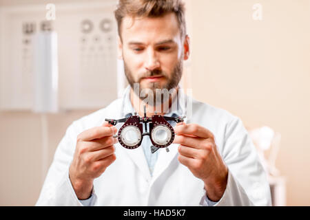 Oculist with try-on tool for lenses Stock Photo