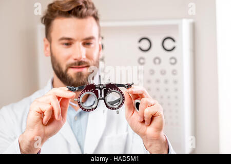 Oculist with try-on tool for lenses Stock Photo