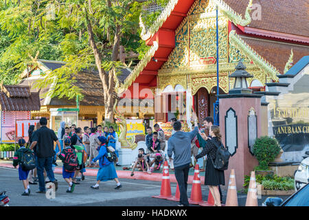 Thai schoolchildren horseplay before school in Chiang Mai, Thailand, November 2016 Stock Photo