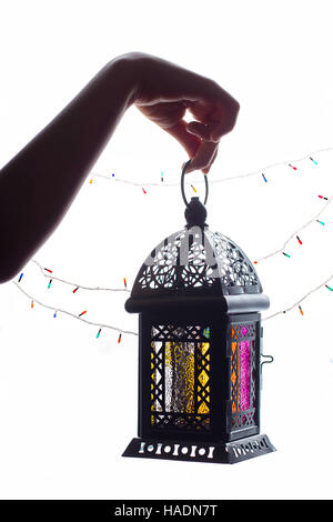 Young Muslim kid hand holding Ramadan lantern (Fanoos) Stock Photo