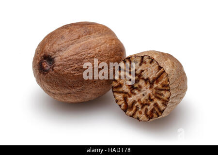 Nutmeg and half nutmeg on white background. Stock Photo