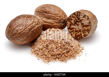 Nutmeg and ground nutmeg on white background. Stock Photo