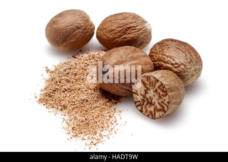 Nutmeg and ground nutmeg on white background. Stock Photo