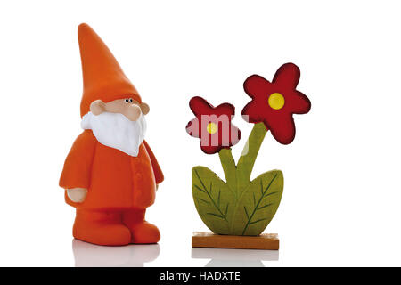 Orange garden gnome beside colored wooden flowers Stock Photo