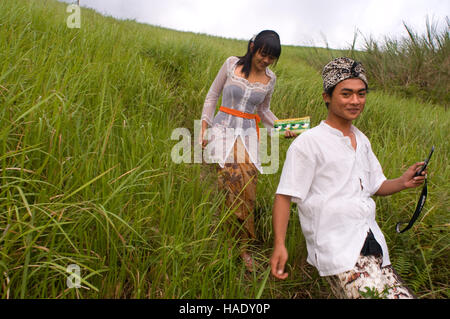 A couple next to rice fields that accompany the walk Campuan crest. Ubud. Bali. On the Campuan ridge walk in Ubud, Bali, beautiful green rice terraces Stock Photo