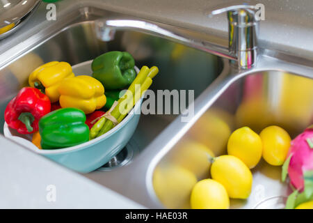 dummy ripe fruits and vegetable in sink at a morden kitchen Stock Photo