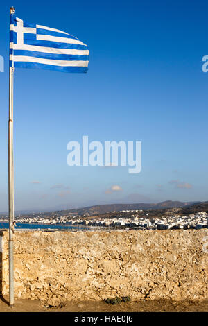 Greek flag flying in the Fortezza ruins above the coastal city of Rethymno, Crete Stock Photo