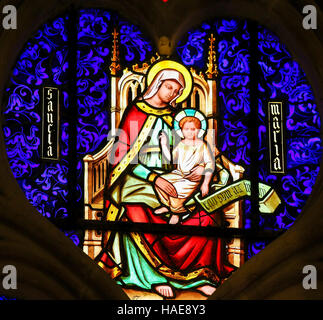 Stained Glass window in the Cathedral of Bayeux, France, depicting Mother Mary with the Child Jesus Stock Photo