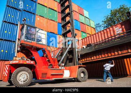 Workers arranging shipping containers at the Port of Jakarta's shipping container terminal in Tanjung Priok, North Jakarta, Jakarta, Indonesia. Stock Photo
