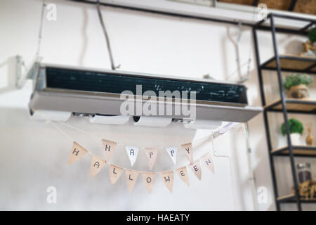 White air conditioner hanging on white wall. Air cool Stock Photo - Alamy
