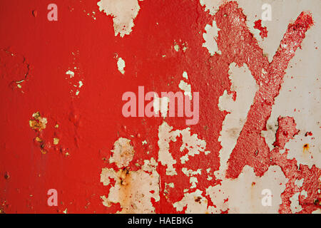 Textured red metal grunge background with peeling distressed paint rust and decay Stock Photo