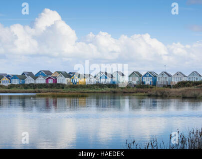 Holloway’s Dock lagoon and Beach Huts at Mudeford Spit or Sandbank, Christchurch Harbour, Stock Photo