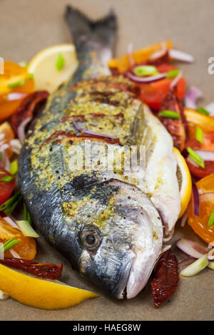 Raw whole sea bream fish and vegetables ingredients, ready to cook Stock Photo