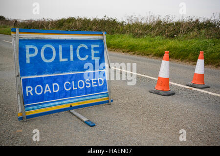 Police Road Closed sign and cones blocking the carriageway during a road traffic collision (RTC). Stock Photo
