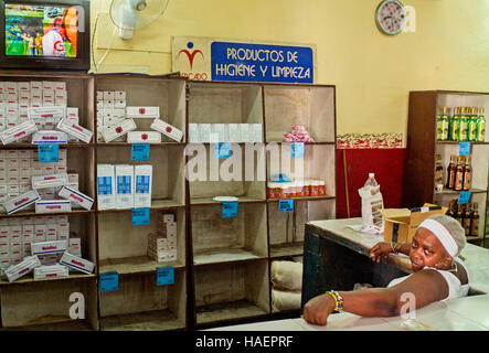 Havana Cuba,government food shop,woman shop assistant watching TV 'productos de higiene y limpieza' Stock Photo