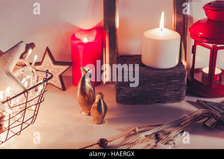 Wooden rustic Christmas decoration in warm and bright scene with burning candles and lights Stock Photo