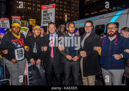 New York Elected Officials, striking fast food workers, supported by airport workers and community, march to nearby McDonald's to protest unfair labor practices and risk arrest - On the four-year anniversary of the first fast food strike in New York, New York workers join the Fight for $15 National Day of Action across the country. Striking fast food workers, supported by airport workers and community, march to McDonald's at 160 Broadway to protest unfair labor practices and risk arrest. The civil disobedience acts in NYC lead to multiple arrests, including several members of the NY City Counc Stock Photo