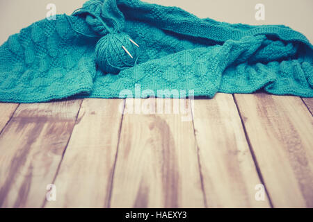 green knitted cloth laying on wooden table, cold vintage Stock Photo