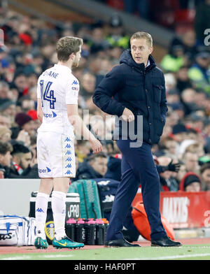 Leeds United's Eunan O'Kane talks to manager Gary Monk after being substituted due to injury during the EFL Cup, Quarter Final match at Anfield, Liverpool. Stock Photo