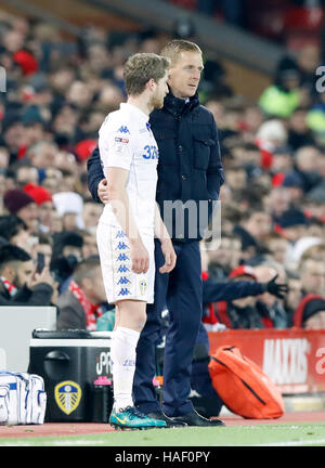 Leeds United's Eunan O'Kane talks to manager Gary Monk after being substituted due to injury during the EFL Cup, Quarter Final match at Anfield, Liverpool. Stock Photo