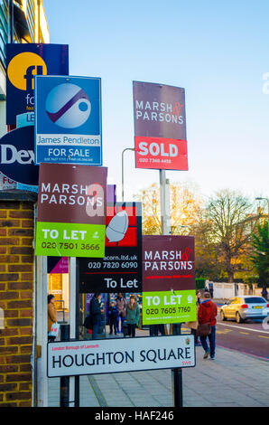 London, UK, 29/11/2016 Estate agent sale and let signs grouped together on the A3 Clapham as rents and house prices rise. Stock Photo