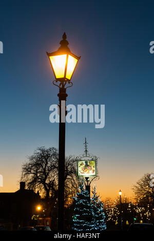 Street lamp, The Lygon Arms sign and Christmas tree decorations. Broadway, Cotswolds, Worcestershire, England Stock Photo
