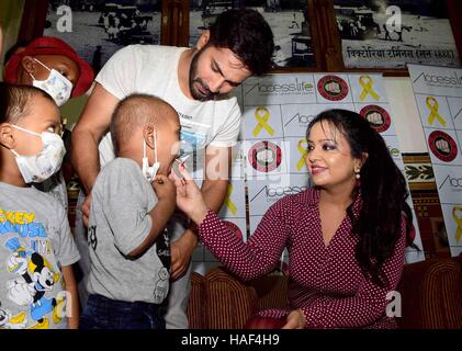 Varun Dhawan Amruta Fadnavis Devendra Fadnavis with cancer affected children visits CST Mumbai Stock Photo