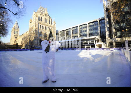 An actor plays The Snowman during a photo call at the Natural History Museum Ice Rink for the theatre production of The Snowman, running at the Peacock Theatre in London. Stock Photo