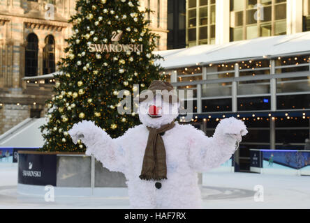 An actor plays The Snowman during a photo call at the Natural History Museum Ice Rink for the theatre production of The Snowman, running at the Peacock Theatre in London. Stock Photo