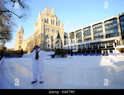 An actor plays The Snowman during a photo call at the Natural History Museum Ice Rink for the theatre production of The Snowman, running at the Peacock Theatre in London. Stock Photo