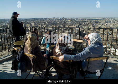 Tourists enjoy the view over Aleppo from the citadel, a large medieval fortified palace, before the civil war. Stock Photo