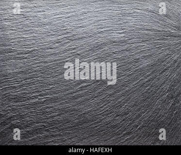 Background of black slate board with the wavy texture Stock Photo