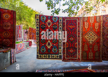 Armenian traditional carpets with traditional ornaments and patterns for sale in Yerevan Armenia. Old fashioned sepia colors. Stock Photo