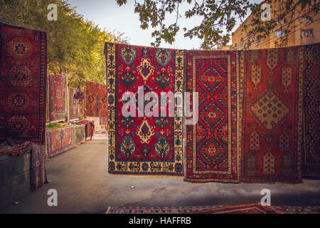 Armenian traditional carpets with traditional ornaments and patterns for sale in Yerevan Armenia. Old fashioned sepia colors. Stock Photo