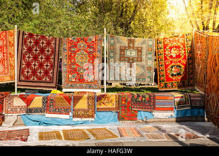 Armenian traditional carpets with traditional ornaments and patterns for sale in Yerevan Armenia. Old fashioned sepia colors. Stock Photo