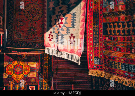 Armenian traditional carpets with traditional ornaments and patterns for sale in Yerevan Armenia. Old fashioned sepia colors. Stock Photo